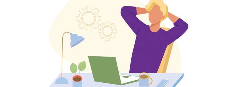 Person sitting at a desk with hands behind head, laptop in front. Purple shirt, yellow hair, neutral background.