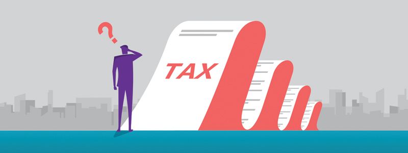 Person beside a red tax form with a question mark over their head, suggesting tax confusion