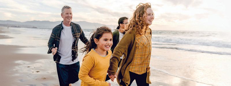 family-running-on-beach