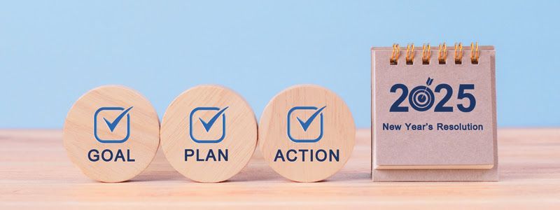 A wooden calendar with a goal , plan , and action written on it.