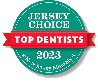 Jersey Choice Top Dentist 2023 award logo: teal circle with a red banner, white text. New Jersey Monthly at bottom.