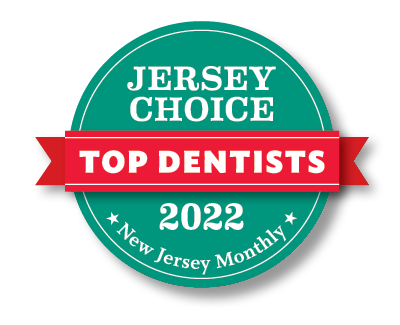 Jersey Choice Top Dentists 2022 award badge. Teal circle with red banner, white text. Published by New Jersey Monthly.