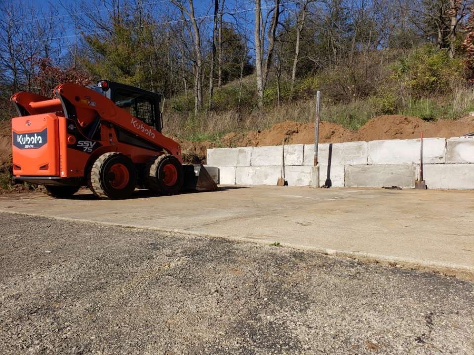 A kubota skid steer is parked on the side of the road.