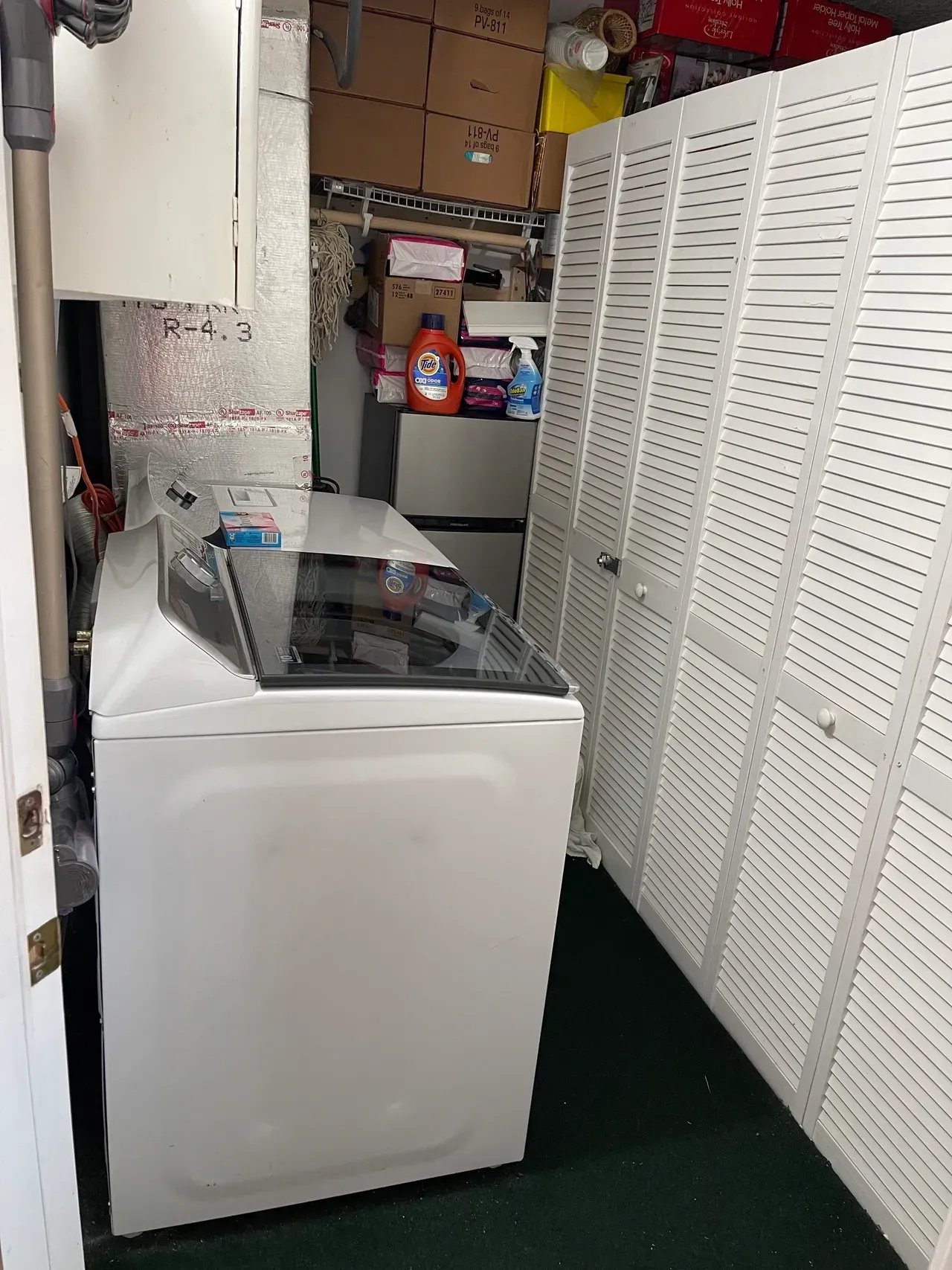 A laundry room with a washer and dryer in it