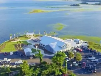 An aerial view of a large building next to a body of water.