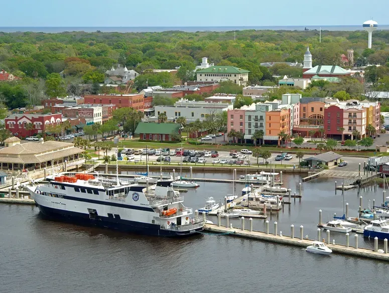 A large ship is docked at a marina in a small town