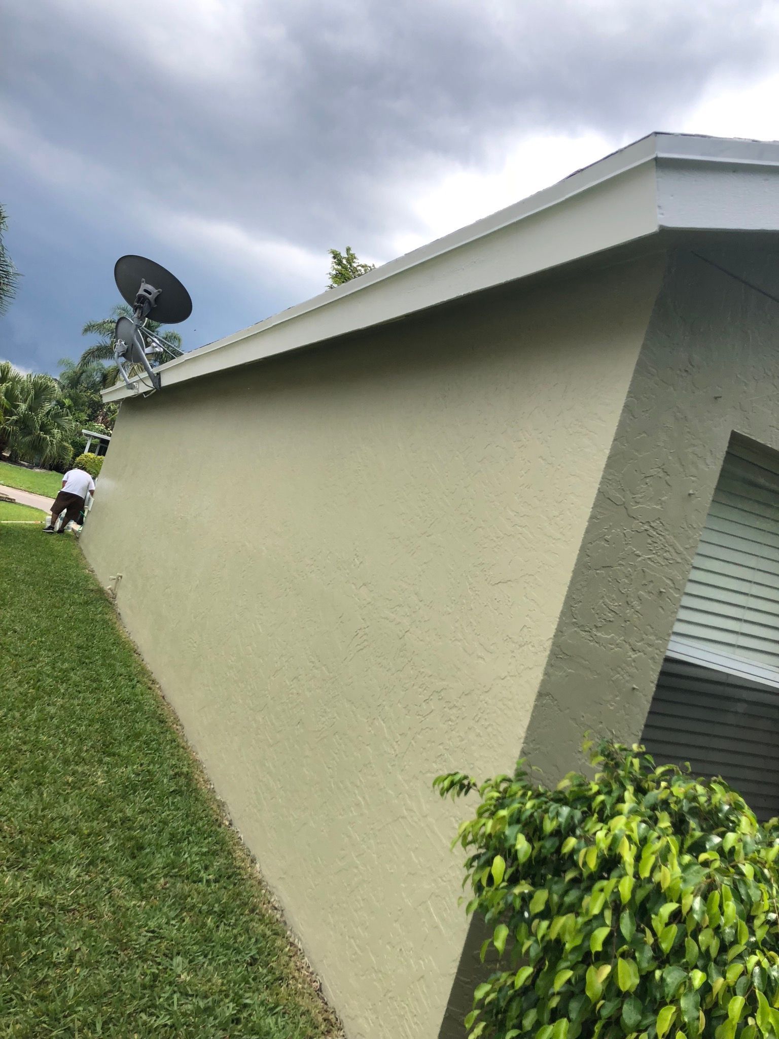 A house with a satellite dish on the side of it.