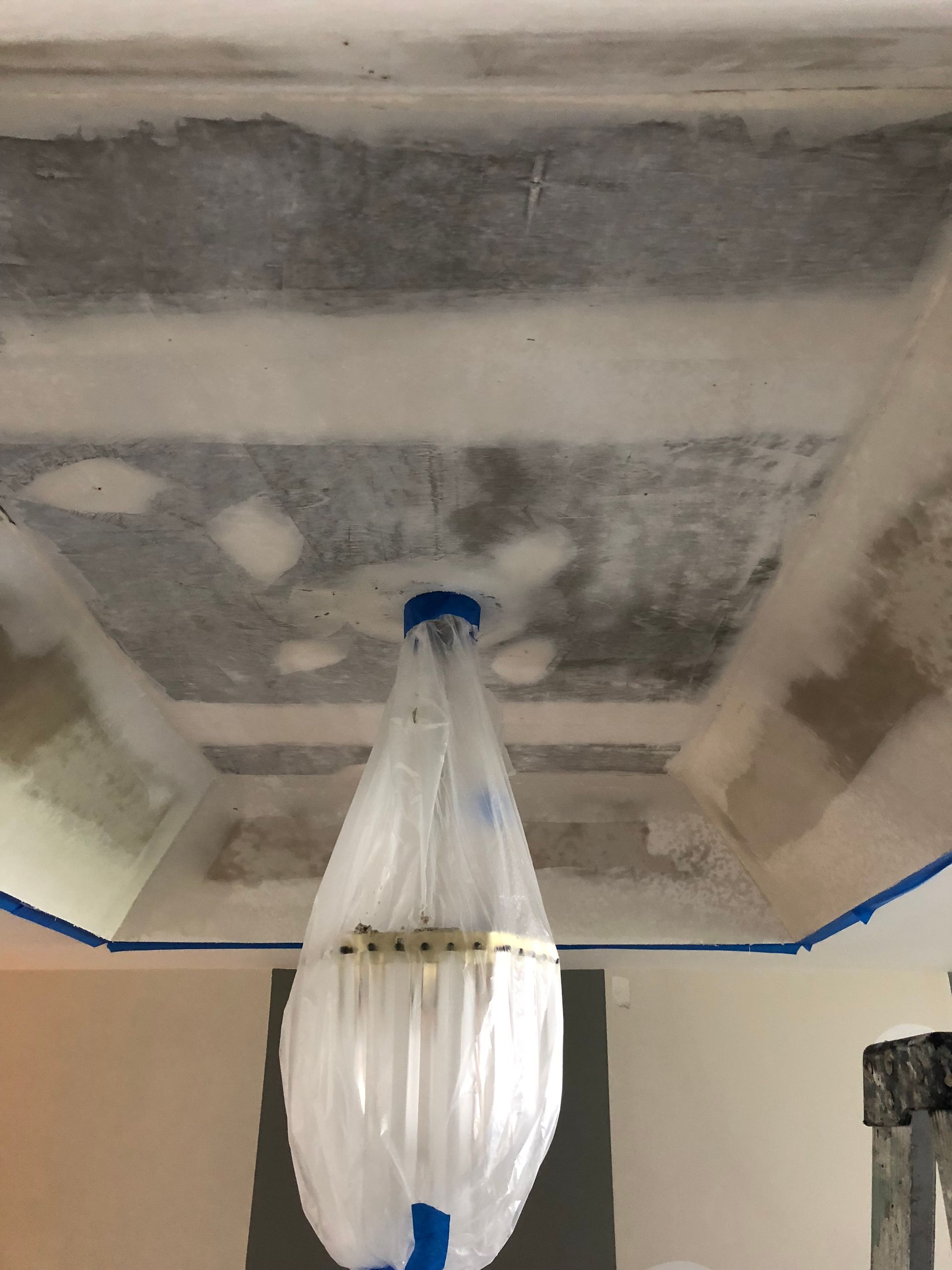 A plastic bag is hanging from the ceiling of a room