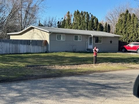 A house with a fire hydrant in front of it.