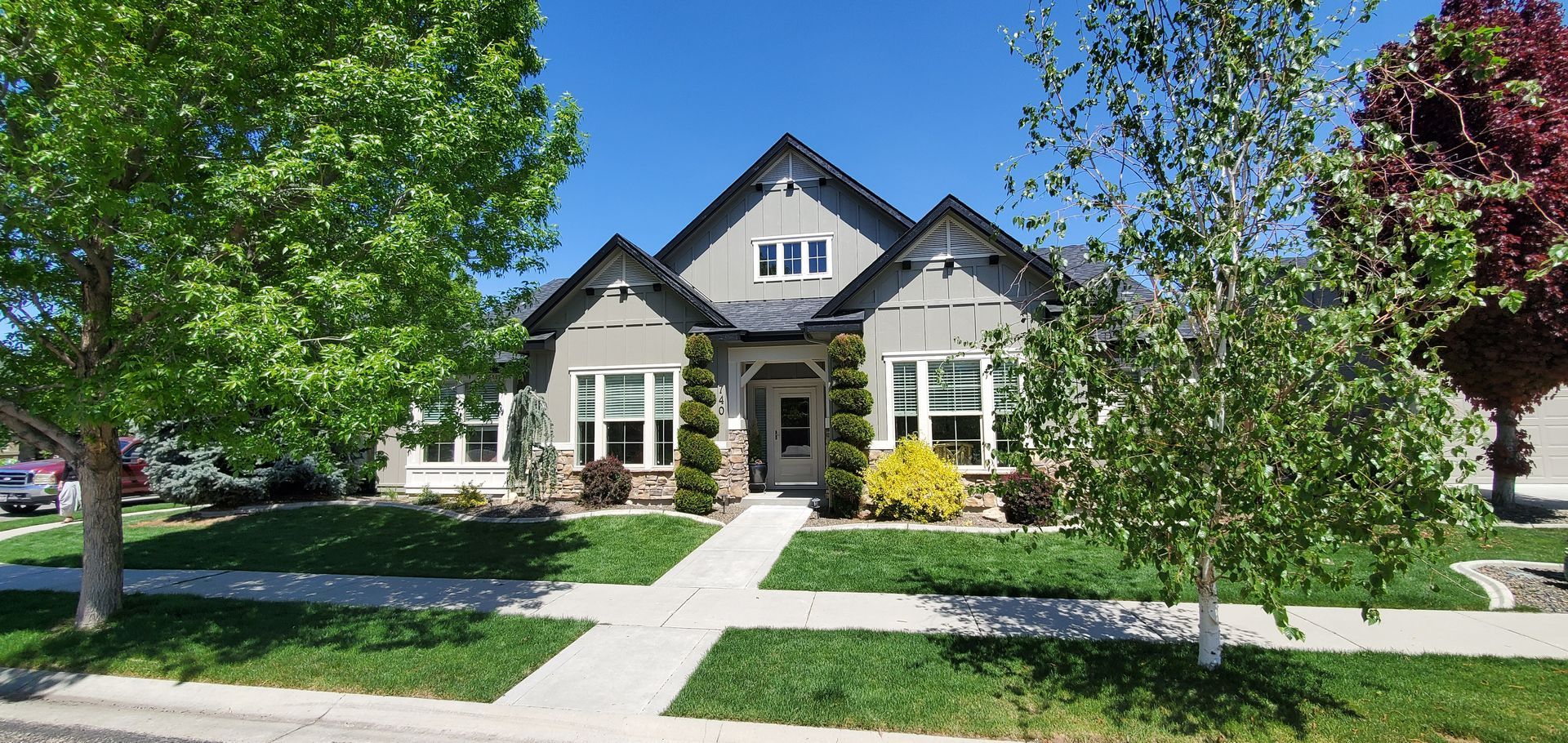 A house with a large lawn in front of it