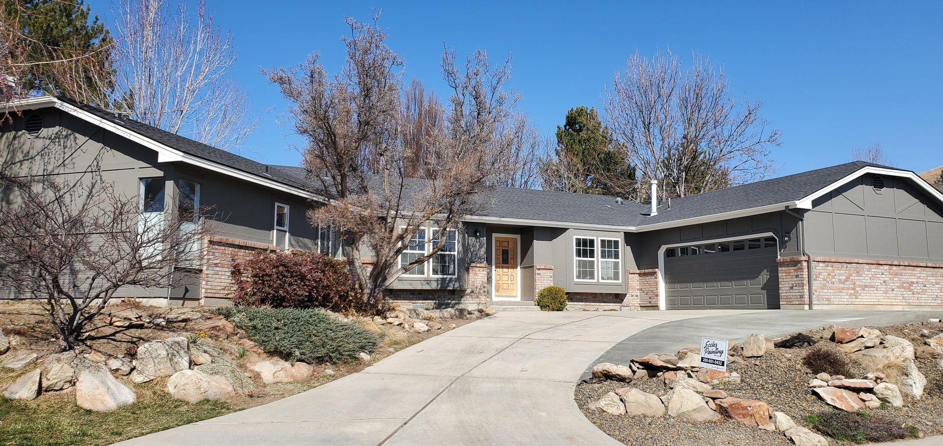 A large house with a concrete driveway leading to it.