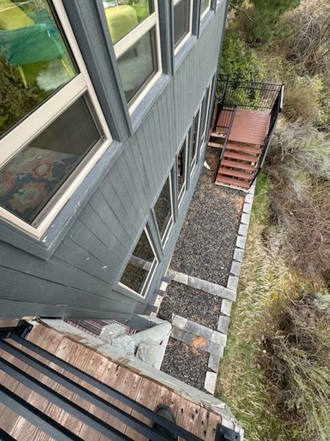 An aerial view of a house with stairs leading up to it.