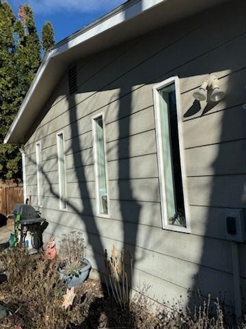 A house with a lot of windows on the side of it.