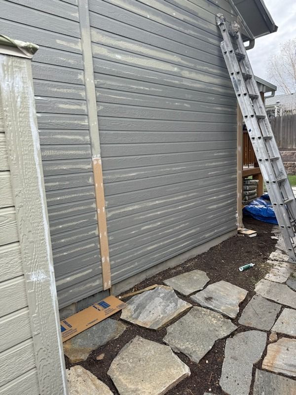 A ladder is leaning against the side of a house.