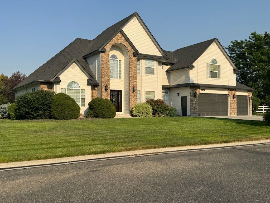 A large house with a lot of windows and a large air conditioner on the side of it.