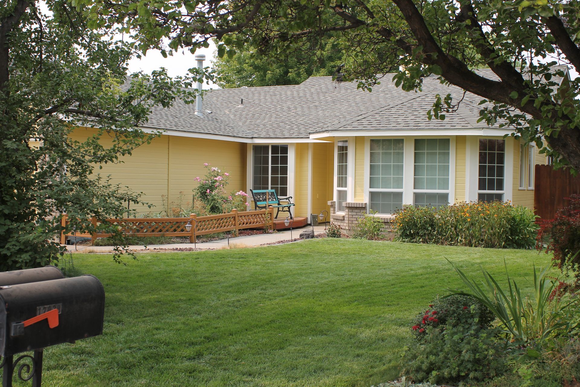 A large house with a lot of windows and a large air conditioner on the side of it.