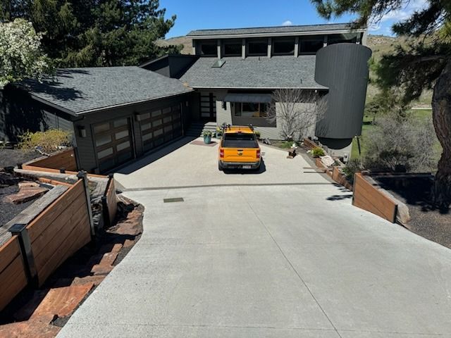 A large house with a basketball hoop in front of it.