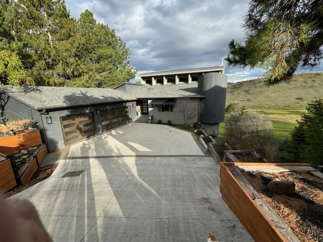 A large house with a basketball hoop in front of it.