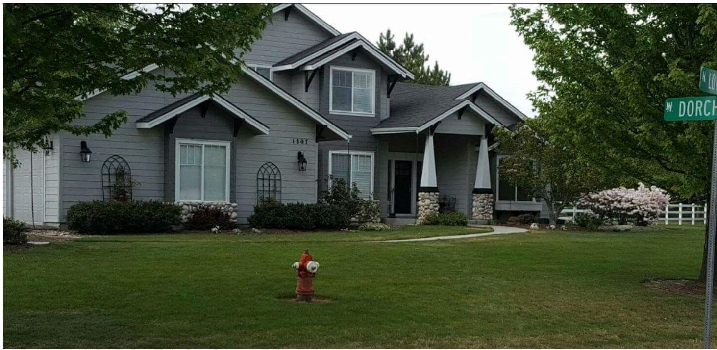 A large house with a concrete driveway leading to it.