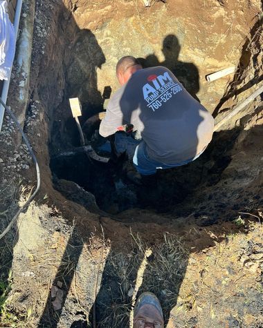 A worker in a gray shirt labeled 