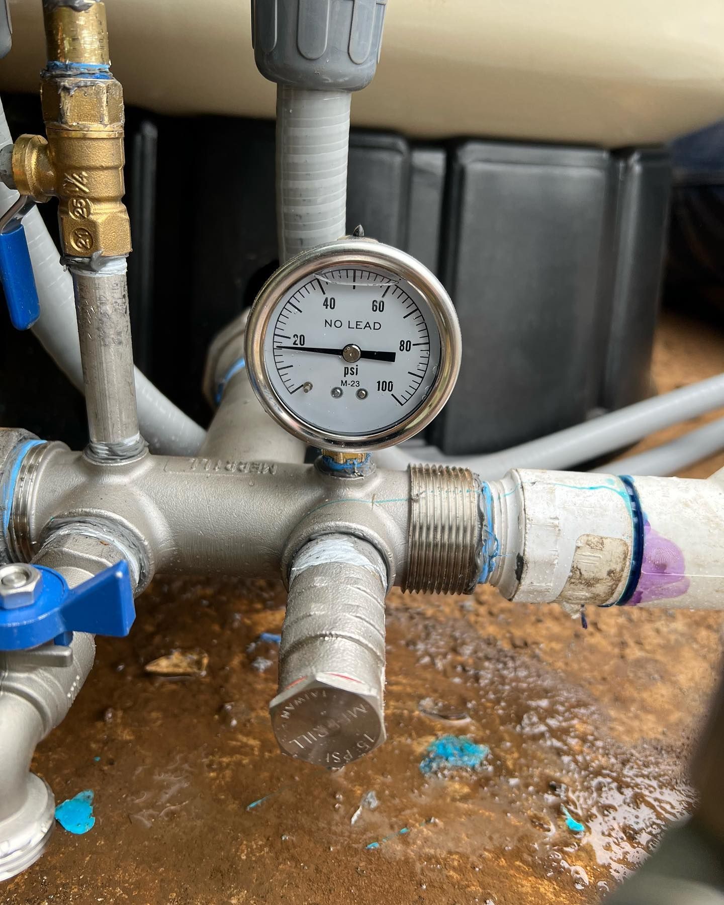 A pressure gauge on a pool plumbing system showing a reading of approximately 18 psi.