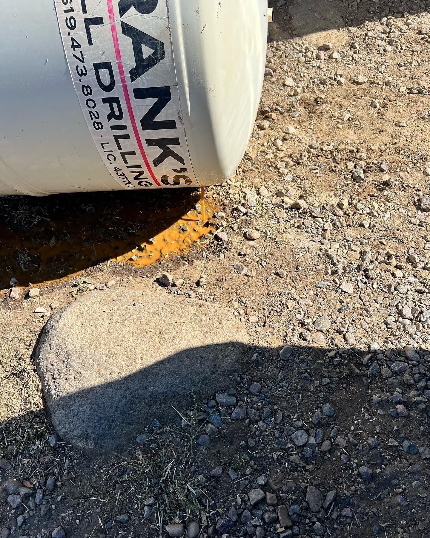 Close-up of a white tank with the text 