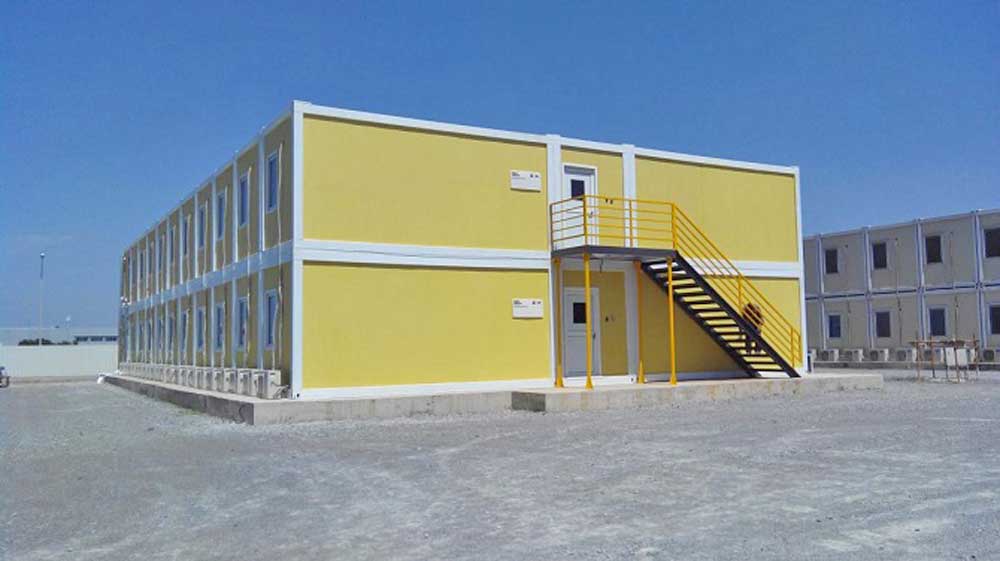 A large yellow building with stairs leading up to it