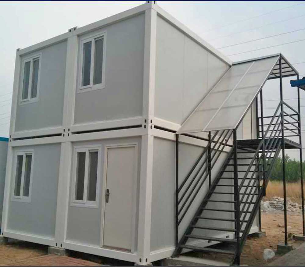 A small white house with stairs leading up to it.