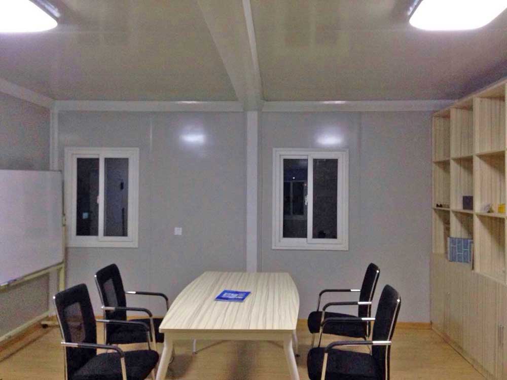A room with a table and chairs in it