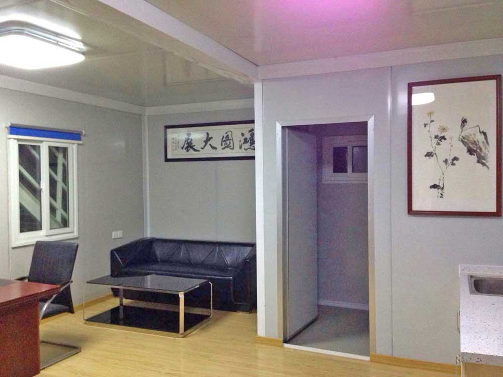 A living room with a couch and a picture on the wall