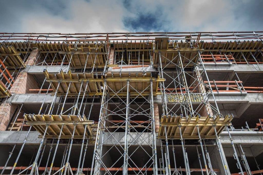 Si sta costruendo un grande edificio circondato da impalcature.
