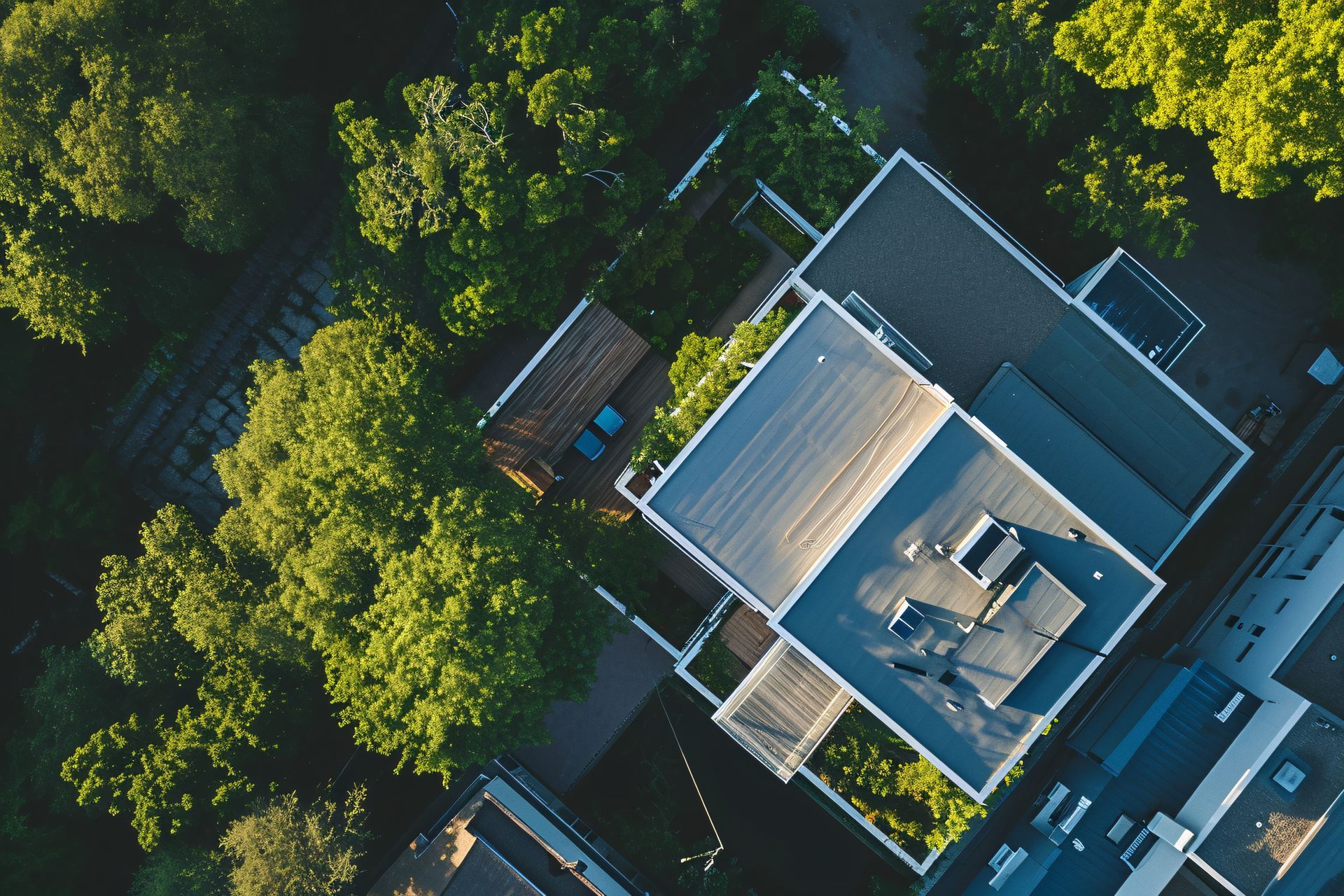 An aerial view of a house surrounded by trees
