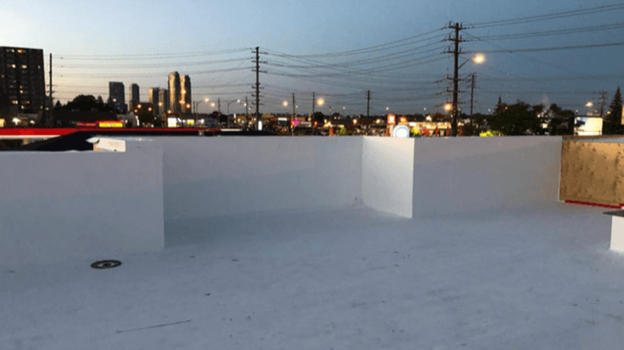 A white roof with a city skyline in the background.