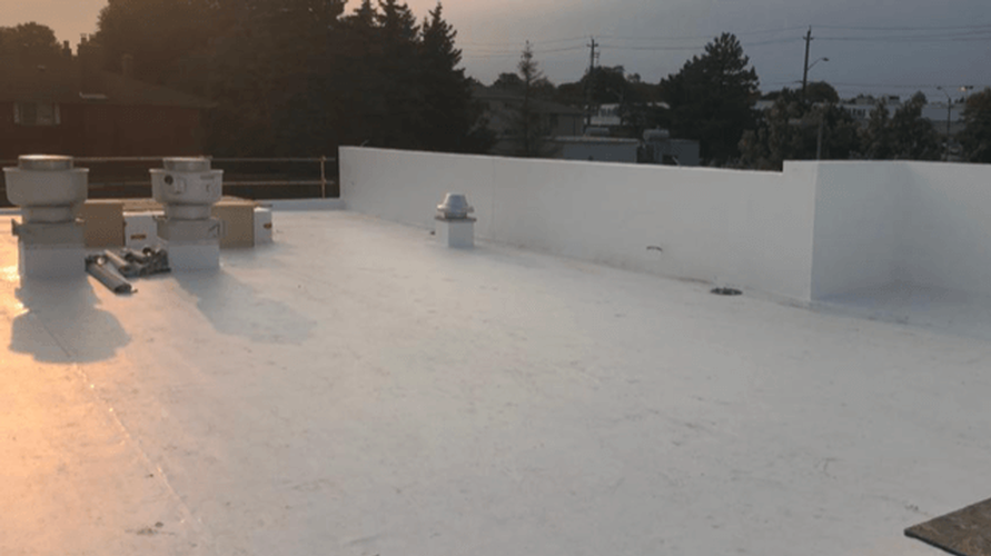 A white roof with a lot of chimneys on it.