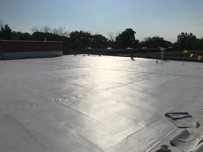 A white roof with a blue sky in the background