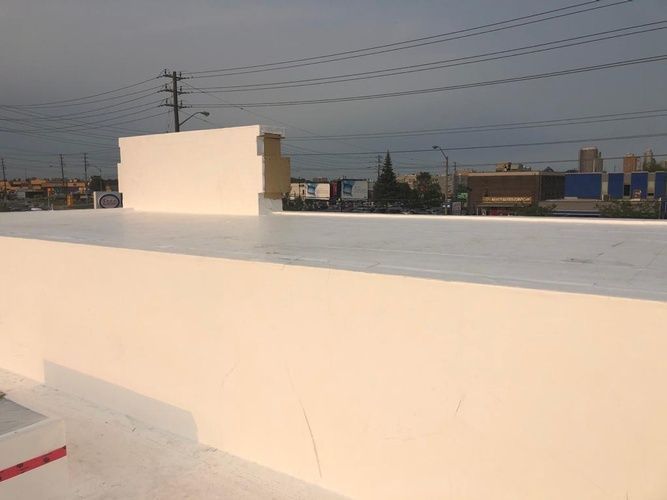 A white roof with a lot of power lines in the background.