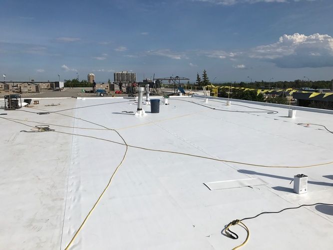 A white roof with a lot of wires on it.