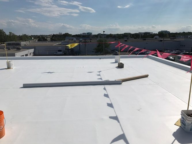 A white roof with a hammer and a brush on it.