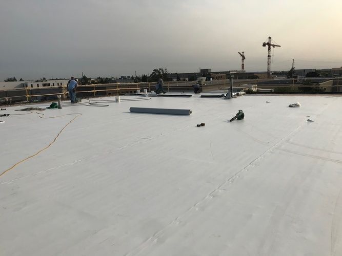 A white roof is being installed on top of a building.