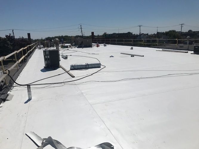 A white roof with a lot of wires on it