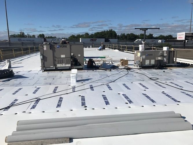 A white roof with a lot of equipment on it.