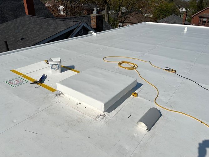 A white roof with a yellow tape measure on it.