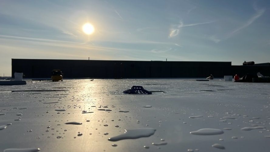 The sun is shining brightly on the roof of a building.