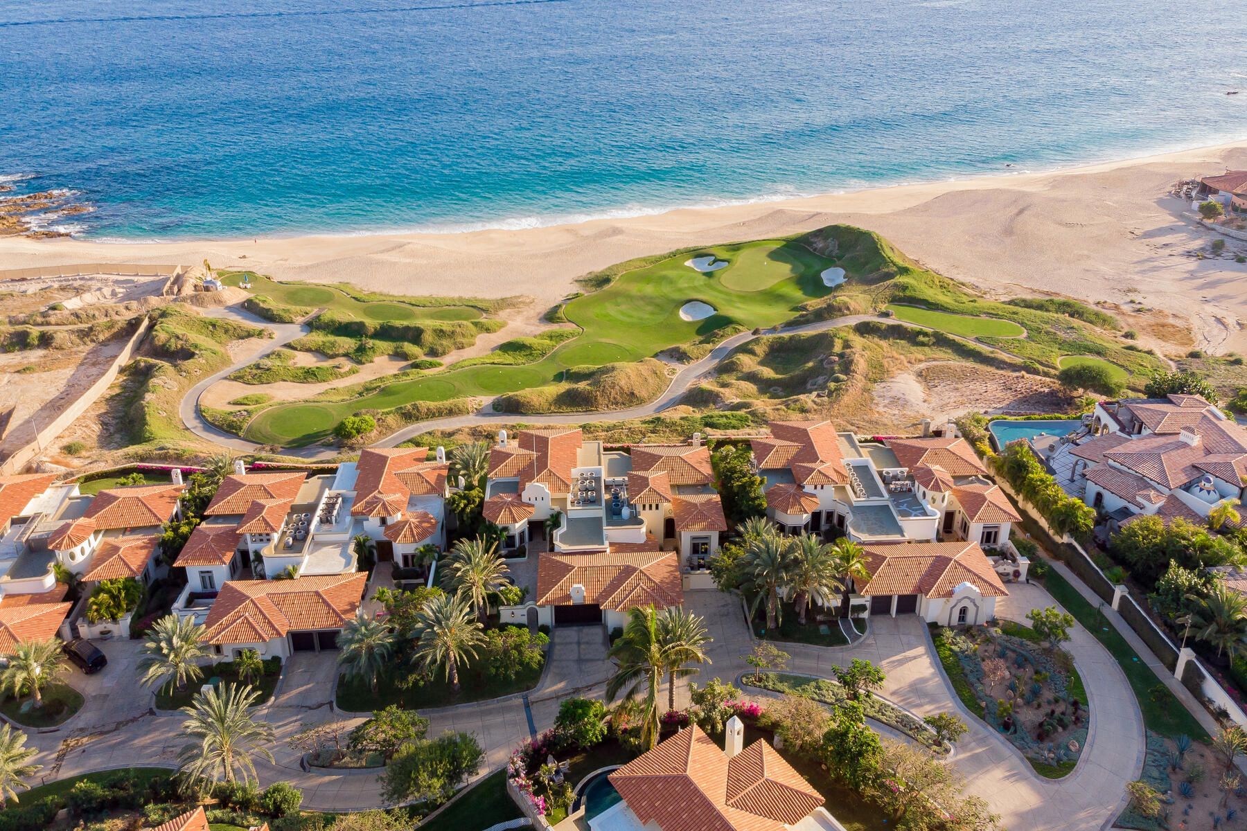 An aerial view of a residential area next to the ocean.