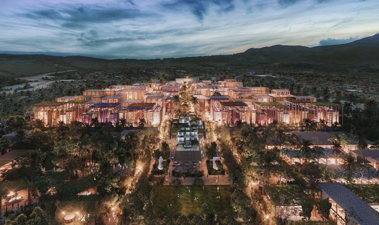 An aerial view of a city surrounded by trees at night.