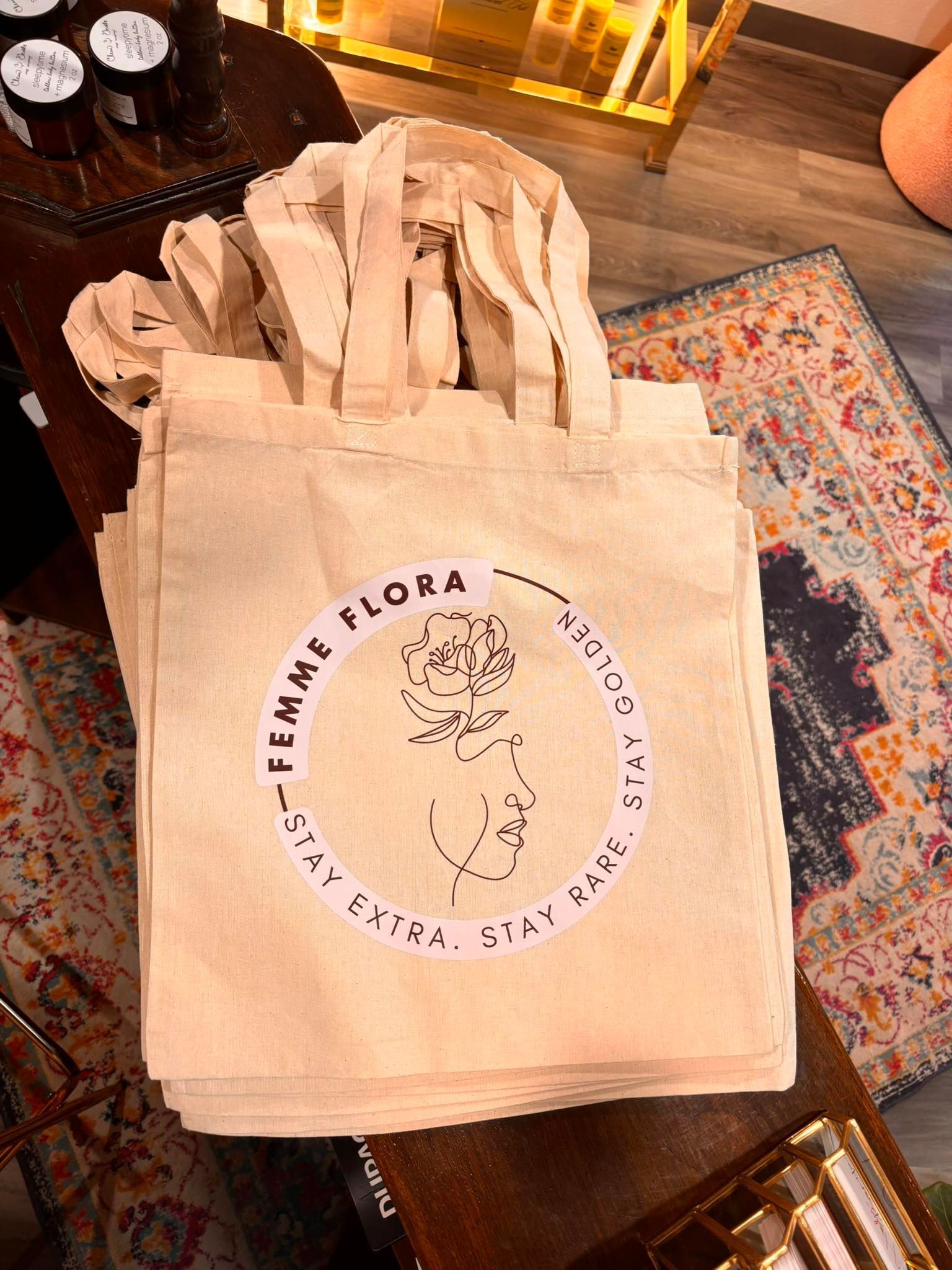 A stack of beige tote bags with 
