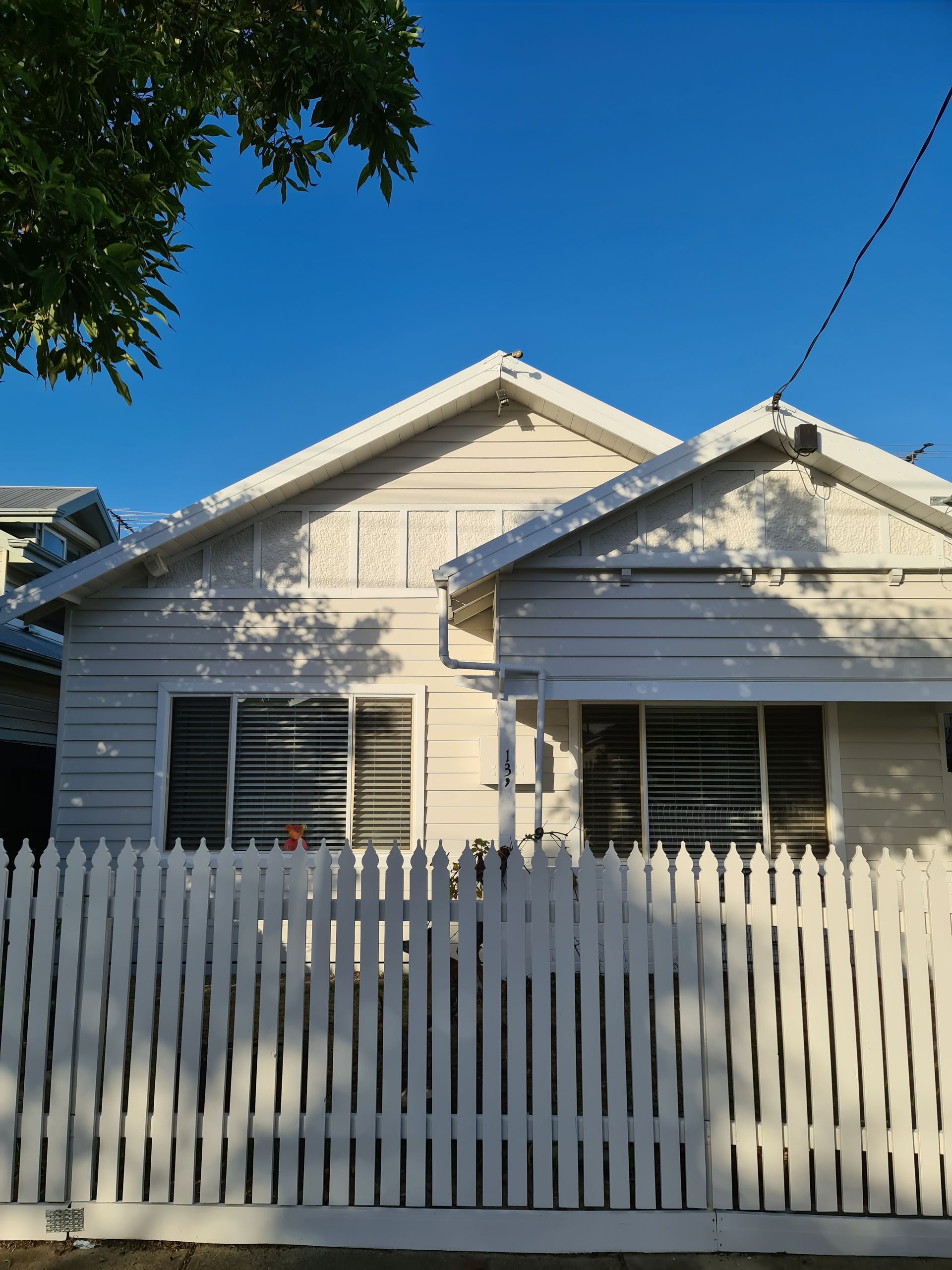 A white house with a white picket fence in front of it