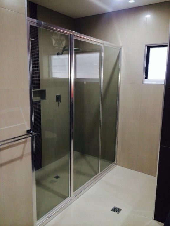 A Bathroom With A Sliding Glass Shower Door — MRS–Mirrors, Robes & Shower Screens In Palmerston, NT