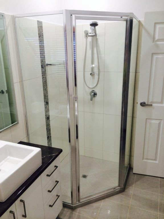A Bathroom With A Walk In Shower And A Sink — MRS–Mirrors, Robes & Shower Screens In Humpty Doo, NT