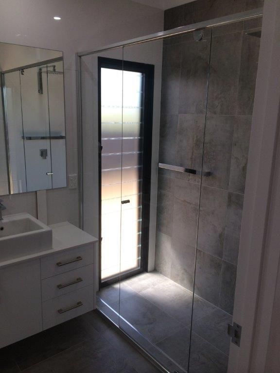 A Bathroom With A Sink And A Walk In Shower — MRS–Mirrors, Robes & Shower Screens In Darwin, NT